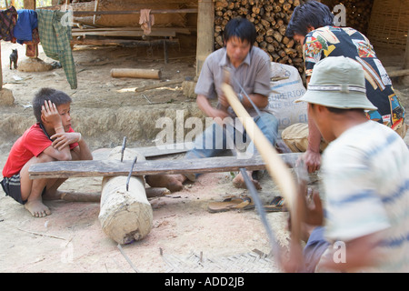 Men Cutting Plank Of Wood With Saw Stock Photo