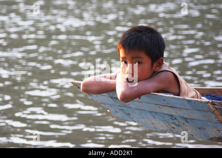 Boy Leaning On Boat Stock Photo