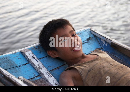 Boy Lying Back On Boat Stock Photo