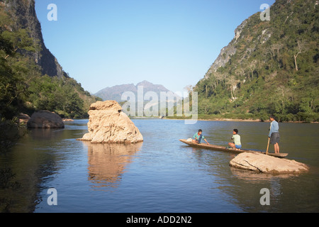 Boys Paddling Boat On Nam Ou River Stock Photo