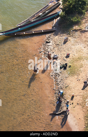 Bird's Eye View Of Women Washing Clothes In Nam Ou River Stock Photo