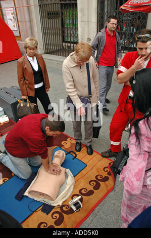 Emergency and first aid training on a street in Warsaw. People learing resuscitation method Stock Photo