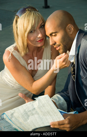 Caucasian blonde woman caressing a black man on neck Stock Photo