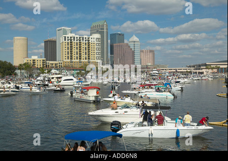 Crowd of boats and boaters along Bayshore boulevard for Gasparilla Pirate Festival Tampa Florida, downtown in background Stock Photo