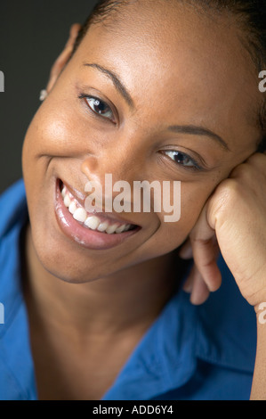 Late twenties African American black female portrait smiling propped by hand Stock Photo