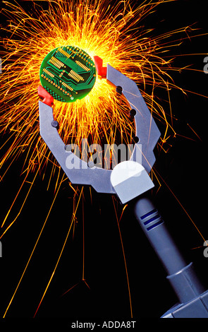 Robot arm holding round circuit board with sparks Stock Photo