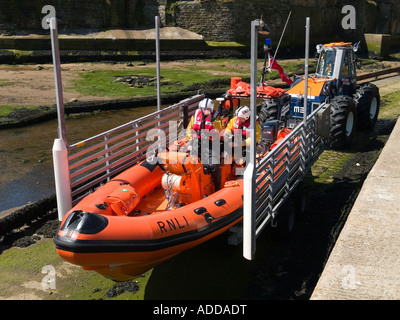 A semi rigid fast rescue craft being launched from the RNLI lifeboat station at Staithes North Yorkshire Stock Photo