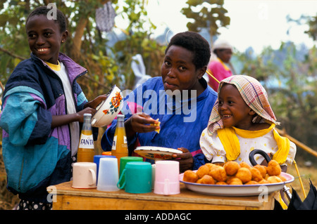 Kashusha camp: A mother her and her two daughters run a little stall at the camp selling snacks soft drinks. Stock Photo