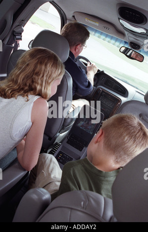 Kids Watch TV in Back of Minivan Stock Photo