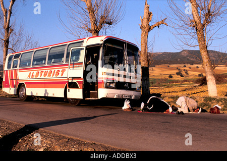 Muslim evangelists visiting Albania stop to pray. Stock Photo