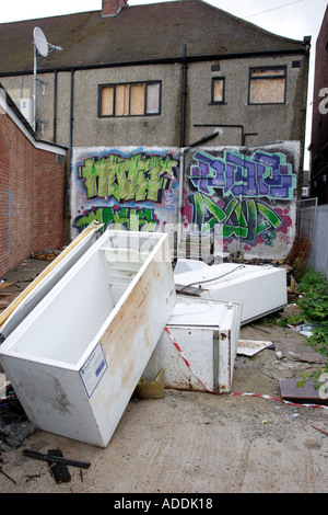 Abandoned fridges and freezers in a back alley behind a parade of shops Stock Photo