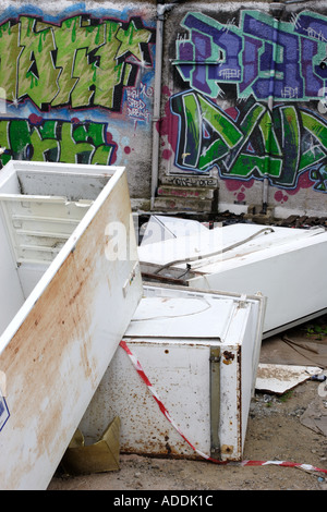 Abandoned fridges and freezers in a back alley behind a parade of shops Stock Photo