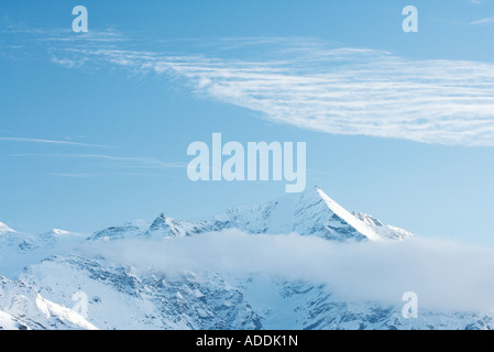 Snow-capped mountain surrounded by clouds Stock Photo