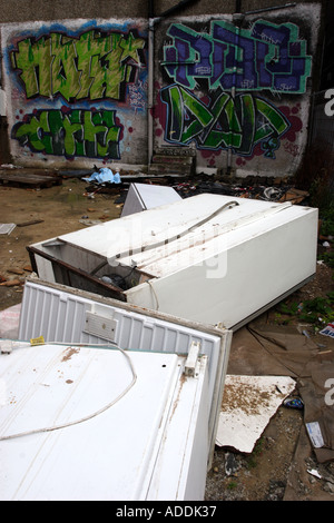 Abandoned fridges and freezers in a back alley behind a parade of shops Stock Photo