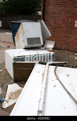 Abandoned fridges and freezers in a back alley behind a parade of shops Stock Photo