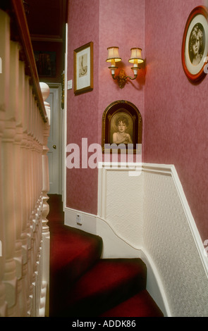 Pink wallpaer in Edwardian hallway North London Stock Photo