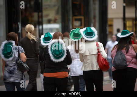Group of women wearing green hats on 