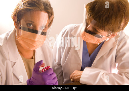 Two research scientists wearing protective masks in their lab. Stock Photo