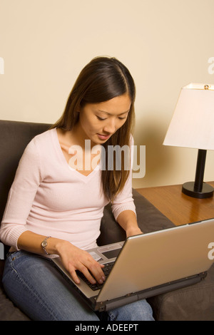 Woman using laptop at home. Stock Photo