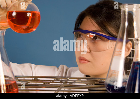 Researcher (model) checking fluids in her lab. Stock Photo