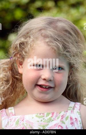 Little blonde girl looking at you. Stock Photo