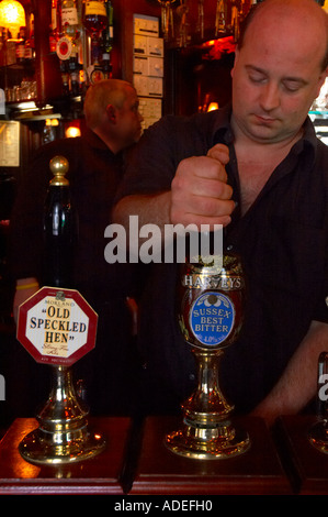 A barman pulling a pint in a pint in Brighton Sussex England UK Stock Photo