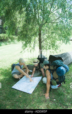 Three hikers studying map Stock Photo