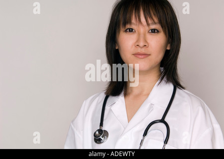 Female Asian doctor with lab coat and stethoscope. Stock Photo