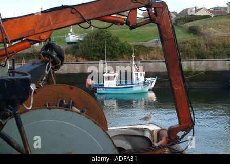 Small Inshore Fishing Boats Framed in Hoist at Eyemouth Harbour Scotland United Kingdom UK Stock Photo