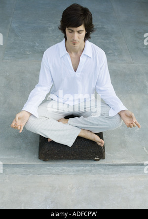 People in lotus positions on beach Stock Photo - Alamy