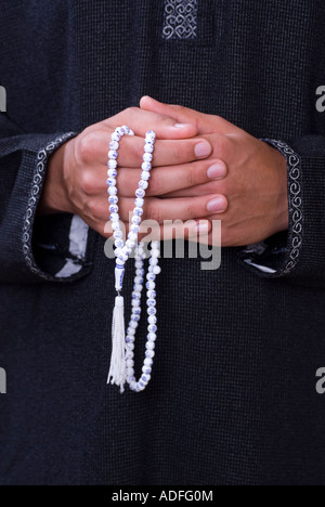 Man holding praying beads Stock Photo