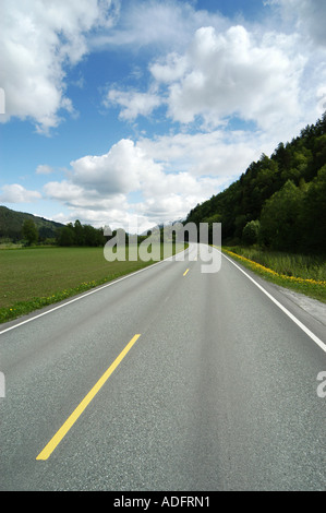 A long straight empty road stretching into the distance Two white ...