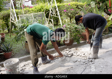 Breaking concrete using jack hammer in Malaysia Stock Photo