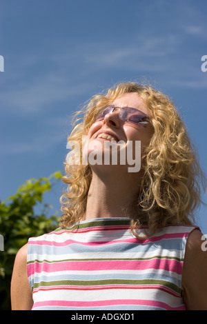 Young woman smiling in sunshine Stock Photo