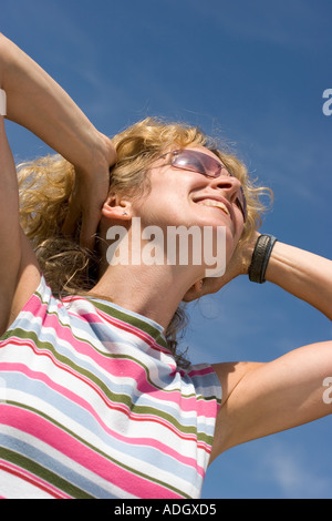 Young woman smiling in sunshine Stock Photo