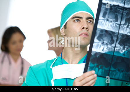Doctor inspecting X rays Stock Photo