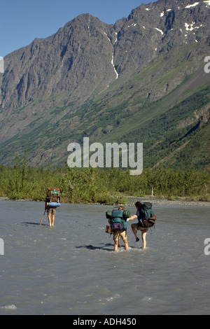 Hikers Cross Wade Across Eagle River SC AK Summer Crow Creek Pass Trail Stock Photo