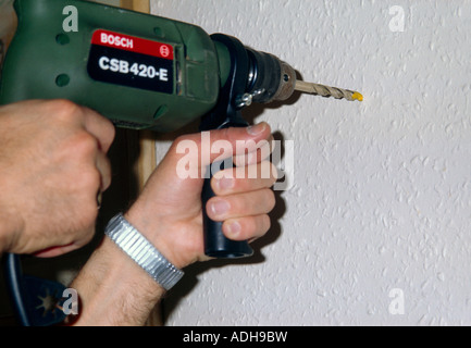Using Electric Drill In House Stock Photo