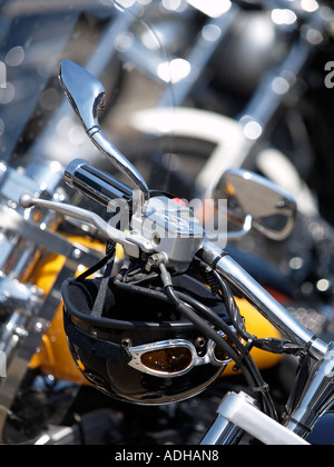 Helmet with goggles hanging from Harley Davidson handlebars Breda the Netherlands Stock Photo