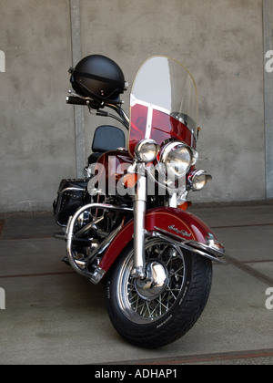Cherry red Harley Davidson Heritage Softail motorcycle parked front view with helmet on the handlebar Breda the Netherlands Stock Photo
