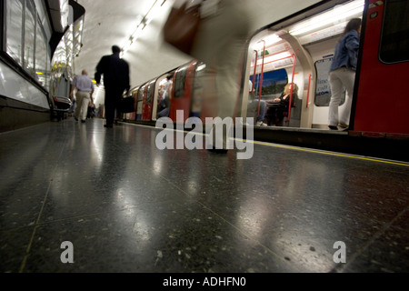 London underground tube network station with passengers commuters getting on and off train Stock Photo