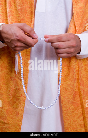 Man praying with praying beads Tasbeeh Stock Photo