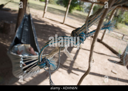 Man Reading Book in Hammock Stock Photo