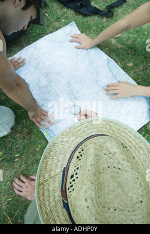 Hikers studying map, using compass Stock Photo