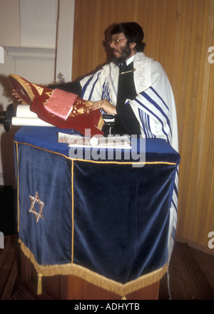 A British rabbi reading from the torah in a Reform Synagogue in south London Stock Photo