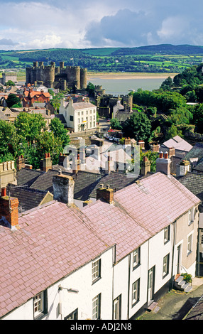 Medieval Conwy Castle, built by King Edward I, Snowdonia, in the Gwynedd region of north Wales. Over rooftops from the town wall Stock Photo