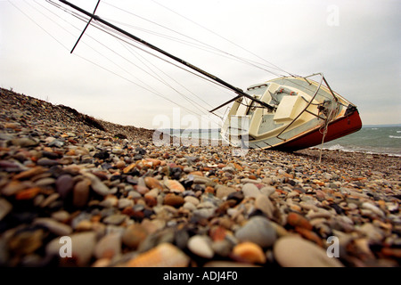 A yacht blown ashore during storms at Portland Harbour in Dorset Britain UK Stock Photo