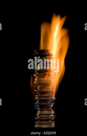 Coins on fire Stock Photo