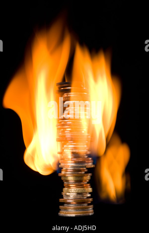 Coins on fire Stock Photo