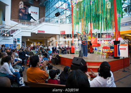 CHICAGO Illinois Adult male entertainer with African American male child on stage Family Pavilion at Navy Pier crowd clap Stock Photo